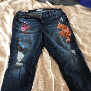 Torrid Ankle length distressed and painted jeans.